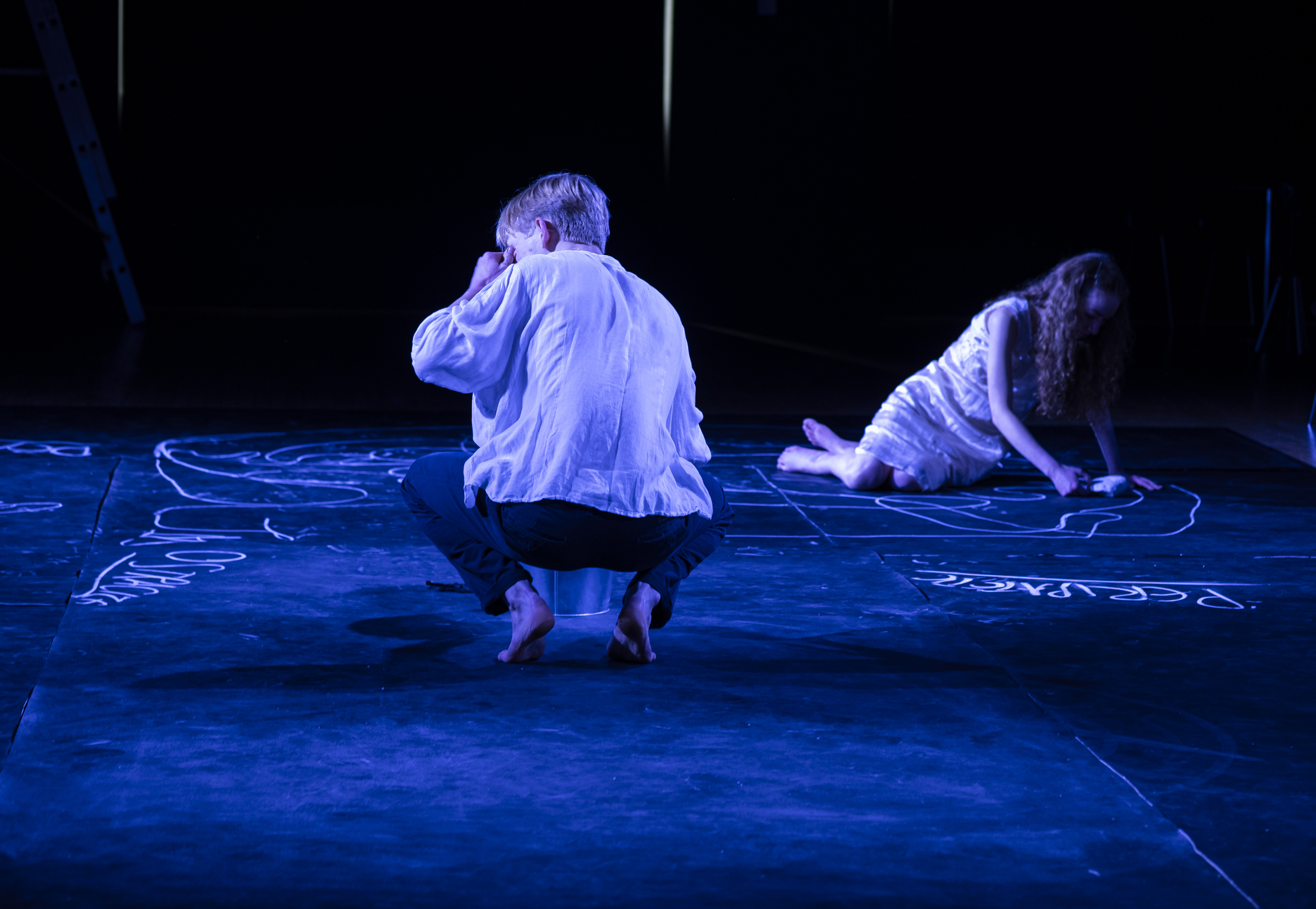Eurydice reaching upward in a wash of cold blue, hair caught in motion.