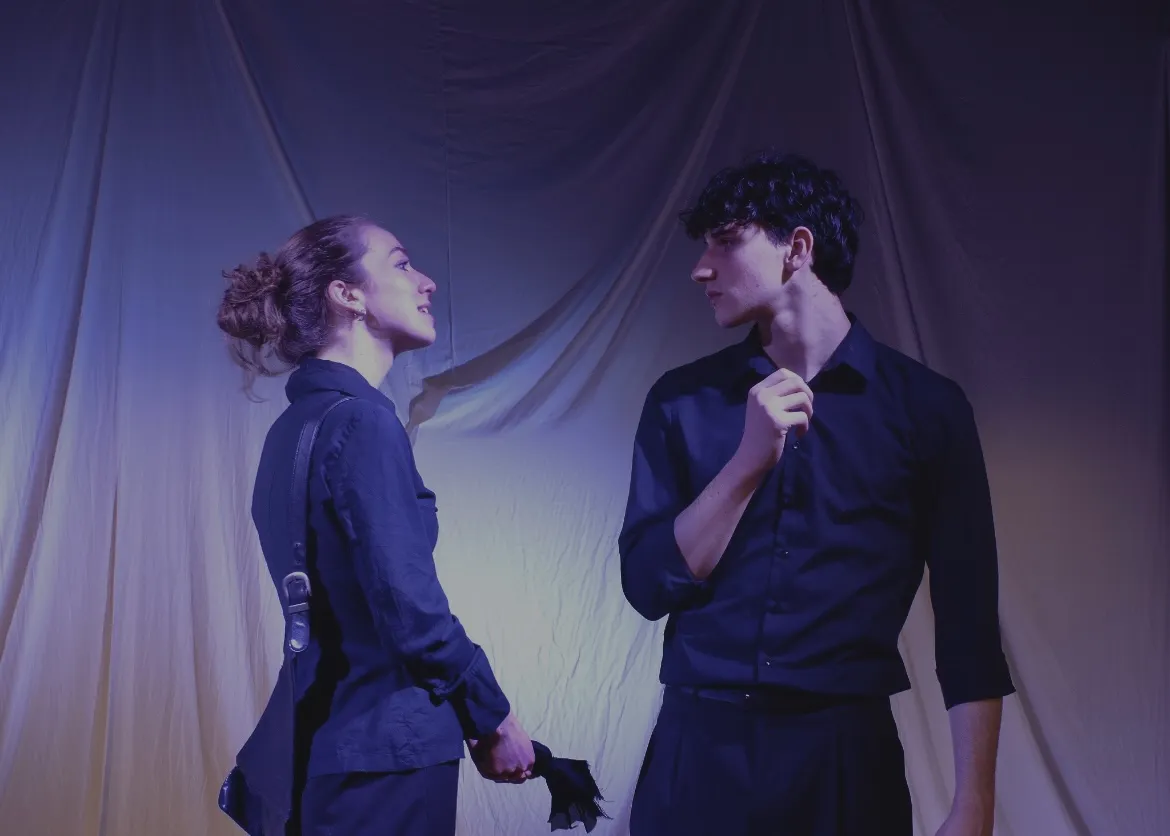 The Duchess and Antonio face each other in warm light, a glove between them.