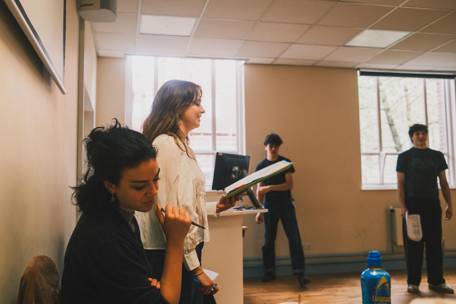 Martha Pardue working with performers in a rehearsal room.