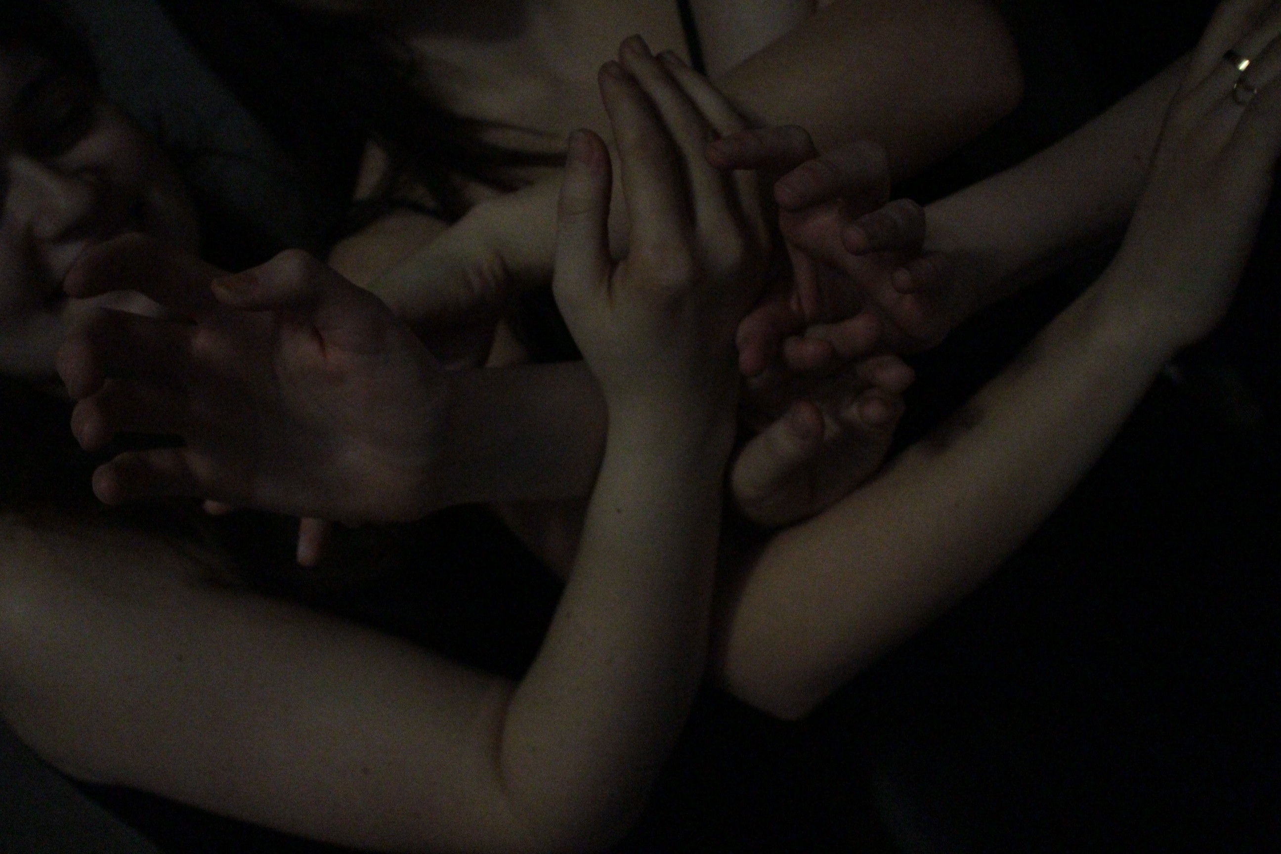 Eurydice onstage, cast in a wash of low light.