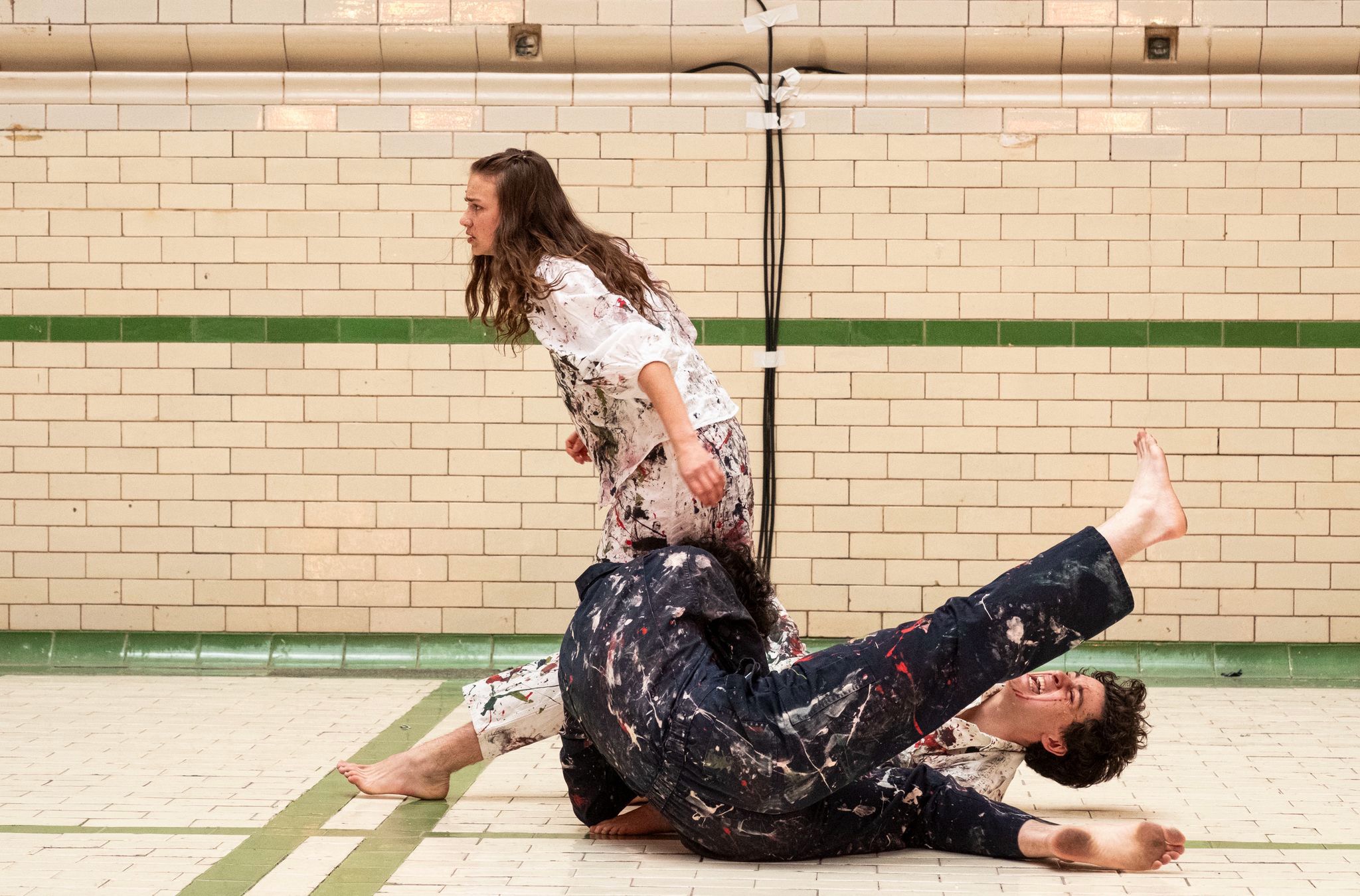 Kate handed off, paint-drenched, in the aftermath of the brawl.