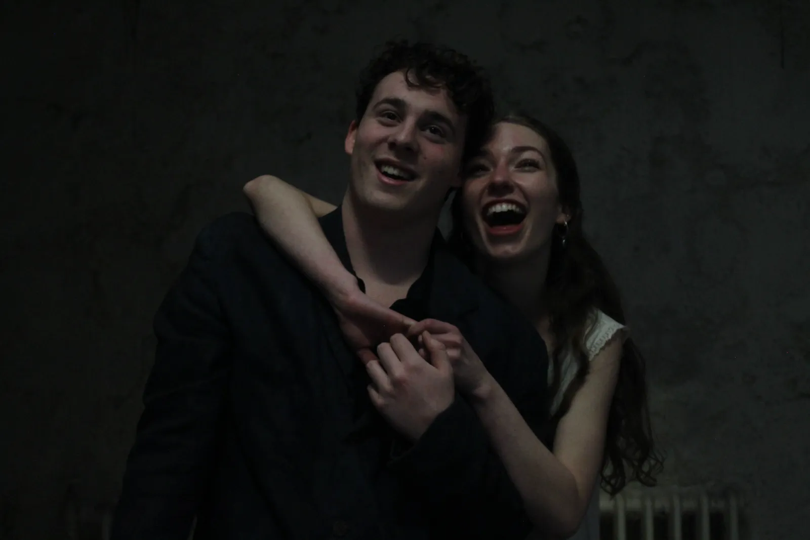 Two of the cast laughing together between takes.